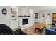 Living room with fireplace, built-in shelving, and comfortable seating, illuminated by natural light at 7804 Wawasee Dr, Indianapolis, IN 46250
