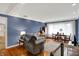 Bright living room featuring hardwood floors, a dining table, and comfortable seating at 7804 Wawasee Dr, Indianapolis, IN 46250