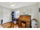 Bright office boasts beautiful hardwood floors, a roll-top desk, and a white ceiling fan at 7804 Wawasee Dr, Indianapolis, IN 46250