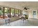 Spacious sunroom features tile flooring, a ceiling fan, and windows providing abundant natural light and outdoor views at 7804 Wawasee Dr, Indianapolis, IN 46250