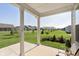 Covered patio offering views of a spacious backyard with lush greenery and neighboring homes at 796 Sapp Cir, Westfield, IN 46074