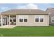 Inviting backyard featuring a covered patio, surrounded by a well-maintained lawn and landscaping at 796 Sapp Cir, Westfield, IN 46074