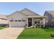 Charming single-story home featuring a two-car garage, inviting front porch, and manicured lawn at 796 Sapp Cir, Westfield, IN 46074