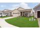 Attractive one-story home with lush green lawn and a cozy front porch seating area, perfect for enjoying the outdoors at 796 Sapp Cir, Westfield, IN 46074
