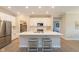 Bright kitchen with a center island, stainless steel appliances, and a view into the adjacent living spaces at 796 Sapp Cir, Westfield, IN 46074