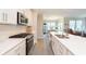 Stylish kitchen with white cabinets, stainless steel appliances, and an island with seating, perfect for cooking and socializing at 796 Sapp Cir, Westfield, IN 46074