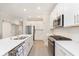 Well-lit kitchen featuring stainless appliances, ample countertop space, and a view into the dining area, creating a cohesive design at 796 Sapp Cir, Westfield, IN 46074