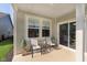 Relaxing outdoor patio featuring comfortable seating, sliding glass doors, and serene backyard views at 796 Sapp Cir, Westfield, IN 46074