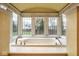 A luxurious bathroom highlighting a large soaking tub with a window view, and a stylish vanity at 8103 N Pennsylvania St, Indianapolis, IN 46240