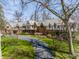 Stately Tudor-style home with a long driveway, manicured lawn, and mature trees at 8103 N Pennsylvania St, Indianapolis, IN 46240