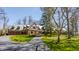 Charming Tudor-style home with a brick facade, slate roof, and a circular driveway at 8103 N Pennsylvania St, Indianapolis, IN 46240