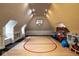 Spacious game room with basketball court, built in shelving, and lots of natural light at 8103 N Pennsylvania St, Indianapolis, IN 46240