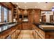 A spacious kitchen featuring beautiful wood cabinets, modern stainless steel appliances, and black countertops at 8103 N Pennsylvania St, Indianapolis, IN 46240