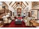 Spacious living room with vaulted ceilings, exposed beams, and a cozy fireplace at 8103 N Pennsylvania St, Indianapolis, IN 46240