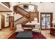 Comfortable seating arrangement in front of a staircase with natural light and hardwood floors at 8103 N Pennsylvania St, Indianapolis, IN 46240