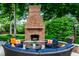 Relaxing outdoor space with a brick fireplace and comfortable seating at 8103 N Pennsylvania St, Indianapolis, IN 46240