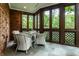 Sunroom with floor to ceiling windows, and a comfortable table with seating at 8103 N Pennsylvania St, Indianapolis, IN 46240