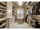A custom walk-in closet with shelving, cabinetry, drawers, and a window seat at 8103 N Pennsylvania St, Indianapolis, IN 46240