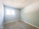 Bright bedroom with plush carpet, fresh paint, and natural light from the window at 8350 Paso Del Norte Ct, Indianapolis, IN 46227