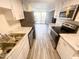 Modern kitchen features stainless steel appliances and white countertops with laminate floors at 8350 Paso Del Norte Ct, Indianapolis, IN 46227