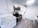 Bright kitchen featuring white subway tile backsplash, white countertops and modern appliances at 8350 Paso Del Norte Ct, Indianapolis, IN 46227