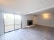 Spacious living room with a fireplace and sliding glass doors to the backyard at 8350 Paso Del Norte Ct, Indianapolis, IN 46227
