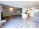 Open layout with living room and kitchen featuring grey wood floors and modern appliances at 8350 Paso Del Norte Ct, Indianapolis, IN 46227