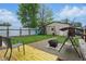 Expansive backyard featuring a playset, storage shed, and a patio with swing, ideal for entertaining at 842 Miller Ave, Shelbyville, IN 46176