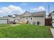 Cozy backyard features green lawn, patio with swing, small deck, storage and privacy fence at 842 Miller Ave, Shelbyville, IN 46176