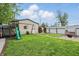 Spacious backyard with playset, storage shed, swing and patio with swing, perfect for outdoor fun at 842 Miller Ave, Shelbyville, IN 46176