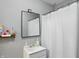 Bathroom featuring a white vanity with mirror, gray walls, and a shower with white curtain at 842 Miller Ave, Shelbyville, IN 46176