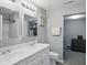 Bathroom featuring a dual sink vanity, medicine cabinet, and a doorway to another room at 842 Miller Ave, Shelbyville, IN 46176