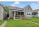 Charming home featuring a covered front porch, manicured lawn, and neutral siding at 842 Miller Ave, Shelbyville, IN 46176