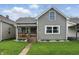 Charming home featuring a covered front porch, manicured lawn, and neutral siding at 842 Miller Ave, Shelbyville, IN 46176