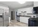 Well-lit kitchen featuring stainless steel appliances, white cabinetry, and gray countertops at 842 Miller Ave, Shelbyville, IN 46176