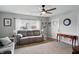 Bright living room with plush seating, ceiling fan, and natural light from the windows at 842 Miller Ave, Shelbyville, IN 46176