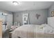 Comfortable bedroom featuring neutral walls, window seat, and doorway to another room at 842 Miller Ave, Shelbyville, IN 46176