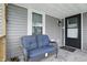 Inviting covered porch featuring a comfortable bench, ideal for relaxing outdoors at 842 Miller Ave, Shelbyville, IN 46176