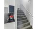 Stairwell featuring a gray carpeted staircase, white railings, and side coffee bar area at 842 Miller Ave, Shelbyville, IN 46176