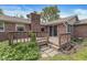 The wooden back deck has brick accents on the house and mature landscaping surrounds at 8814 E 146Th St, Noblesville, IN 46060