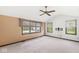 Spacious bedroom with neutral carpet, large windows, and a ceiling fan at 8814 E 146Th St, Noblesville, IN 46060