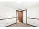 Spacious bedroom with wainscoting, neutral carpet, and doorways to other rooms at 8814 E 146Th St, Noblesville, IN 46060