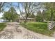 A single-story brick home with an extended driveway and a lush green lawn on a sunny day at 8814 E 146Th St, Noblesville, IN 46060