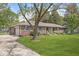 A single-story brick home with an attached garage, a well-kept lawn, and mature trees at 8814 E 146Th St, Noblesville, IN 46060