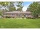 Charming single-story brick home with a well-manicured lawn, mature trees, and inviting curb appeal at 8814 E 146Th St, Noblesville, IN 46060