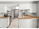 Spacious kitchen boasts white cabinetry, stainless steel appliances, and a breakfast bar with laminate countertops at 8814 E 146Th St, Noblesville, IN 46060