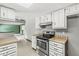 Updated kitchen with stainless steel appliances and wood-look countertops, seamlessly connected to an adjacent living space at 8814 E 146Th St, Noblesville, IN 46060