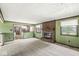 Open-concept living area featuring fireplace, plush carpeting and kitchen access at 8814 E 146Th St, Noblesville, IN 46060