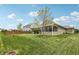 Spacious backyard with lush lawn and screened-in porch offers ideal outdoor living and entertaining space at 8855 Banner Dr, Brownsburg, IN 46112