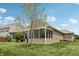 Landscaped backyard featuring a screened-in porch, offering a private and relaxing outdoor space at 8855 Banner Dr, Brownsburg, IN 46112